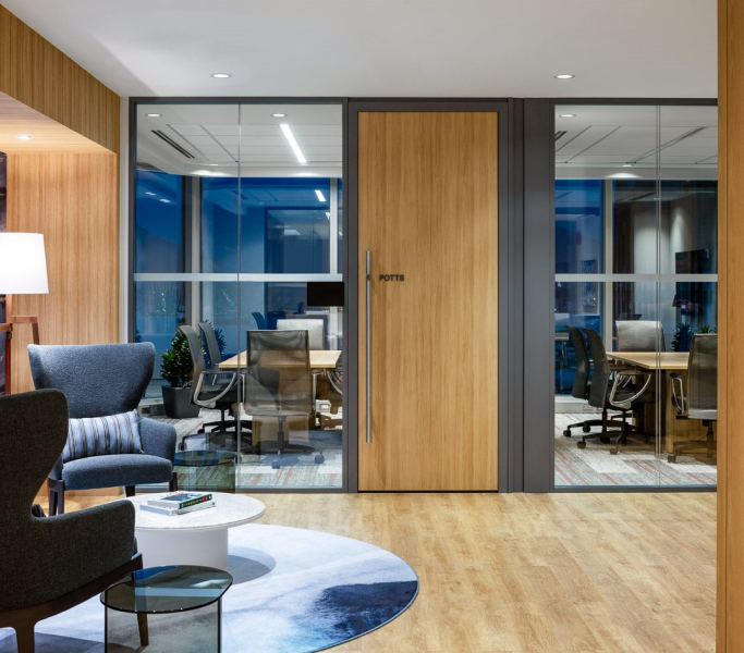 alt="Movable glass walls installed by Systemax in modern office space."