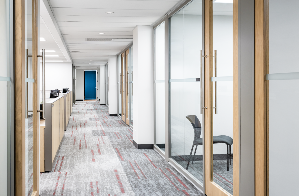 alt="Movable glass walls installed by Systemax in modern office space."
