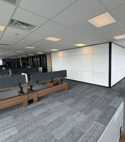 alt="Movable glass walls installed by Systemax in modern office space."